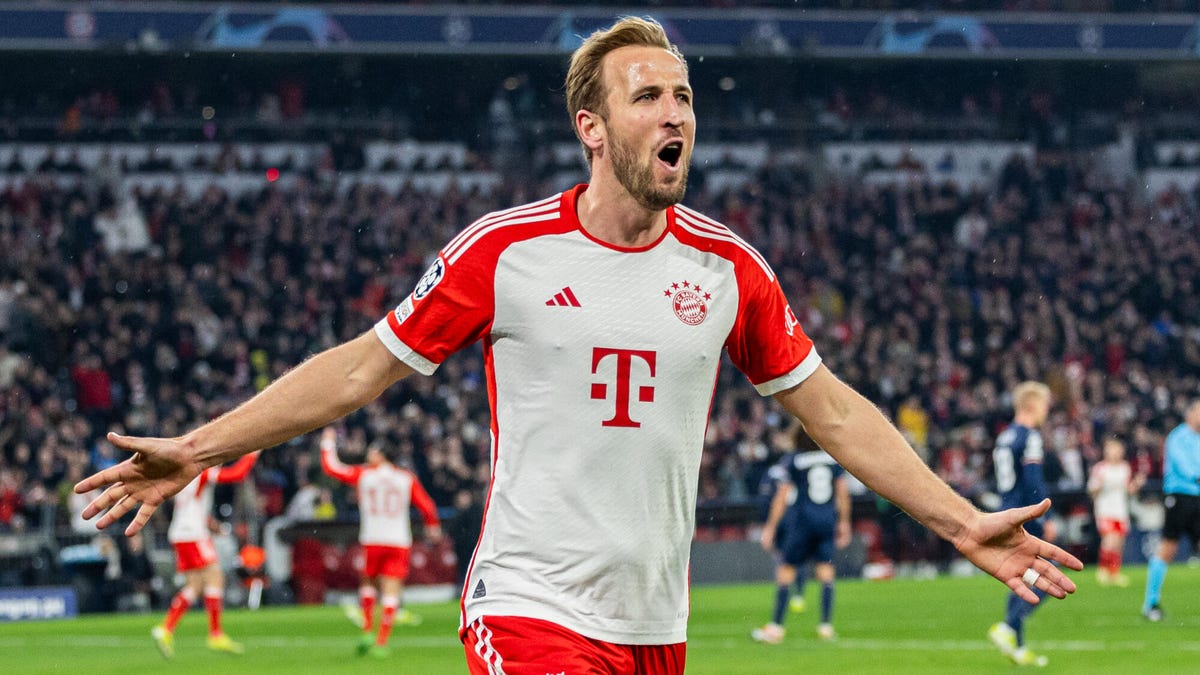 Harry Kane of Bayern Munich, running while celebrating, with arms at his side, outstretched.