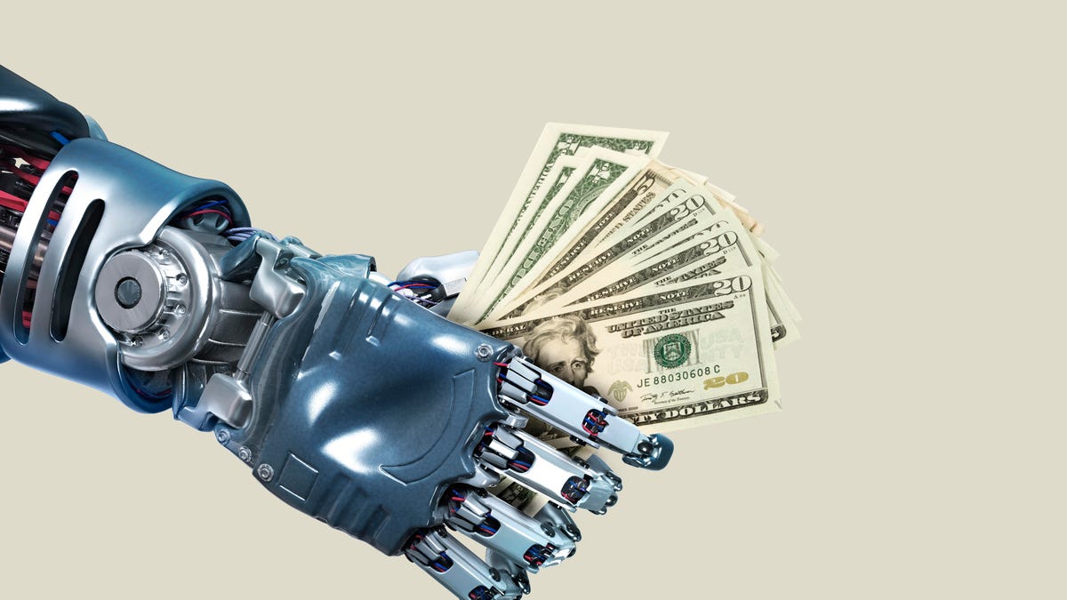 Robot hand holding lots of dollar notes