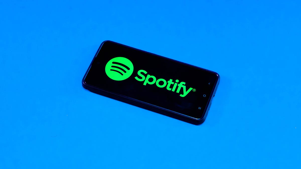 Spotify logo on a phone on a blue background