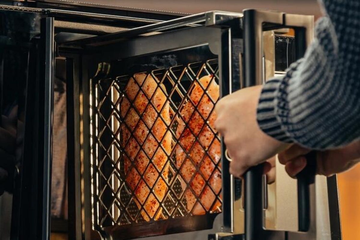 indoor grill with chicken in cage