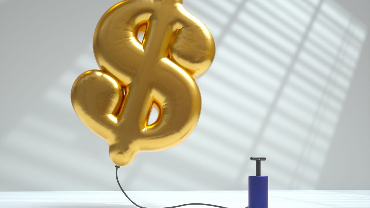 inflated dollar sign balloon hovering