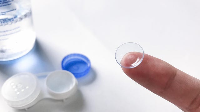 Close-up of finger showing contact lens