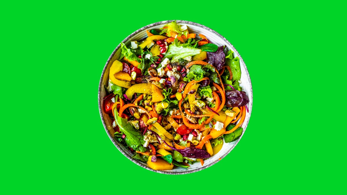 a healthy salad in a round bowl with colorful ingredients