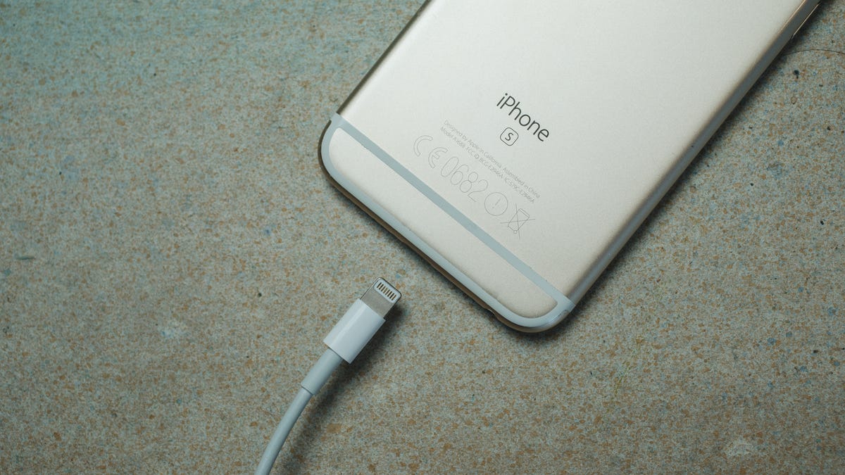 iPhone with power cable about to be plugged in