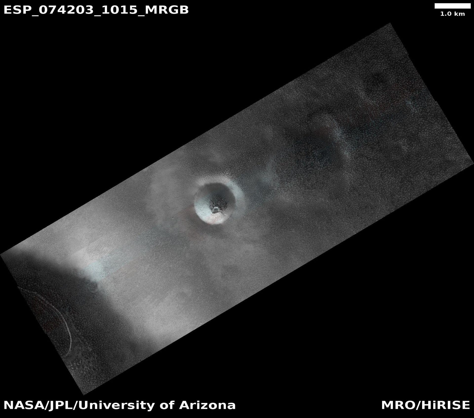 MRO view of Mars shows a diagonal strip of surface with a prominent crater in the center.