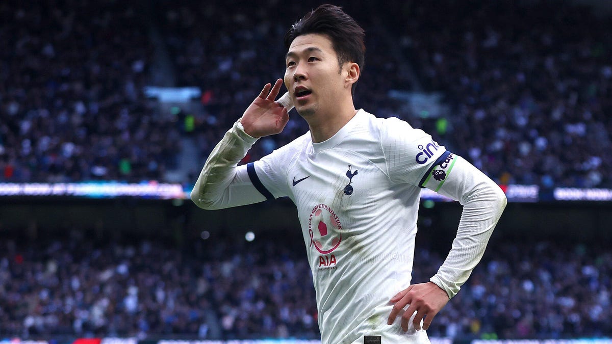 Heung-Min Son of Tottenham Hotspur celebrate g, holding his right hand to his ear.