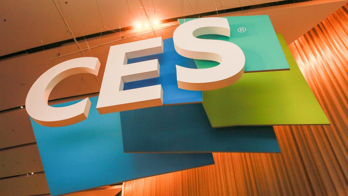 the CES logo hangs from a trade show ceiling