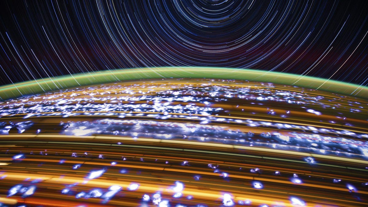 Glorious streaks of orange, yellow, green and blue light show the movement of lights on Earth and stars in space.