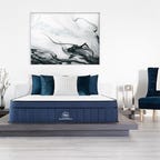The cooling mattress from Brooklyn Bedding on a platform bed frame in a large white room