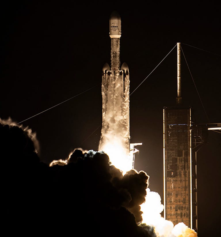 HughesNet Jupiter 3 satellite launching atop a SpaceX rocket at night