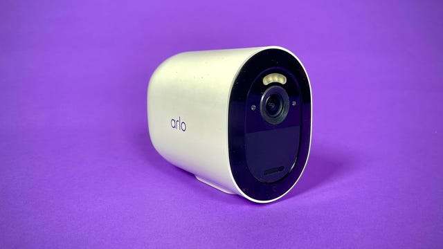 The Arlo Go 2 security camera against a purple background.