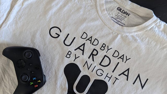 fWhite t-shirt with dad by day, guardian by not printed on it