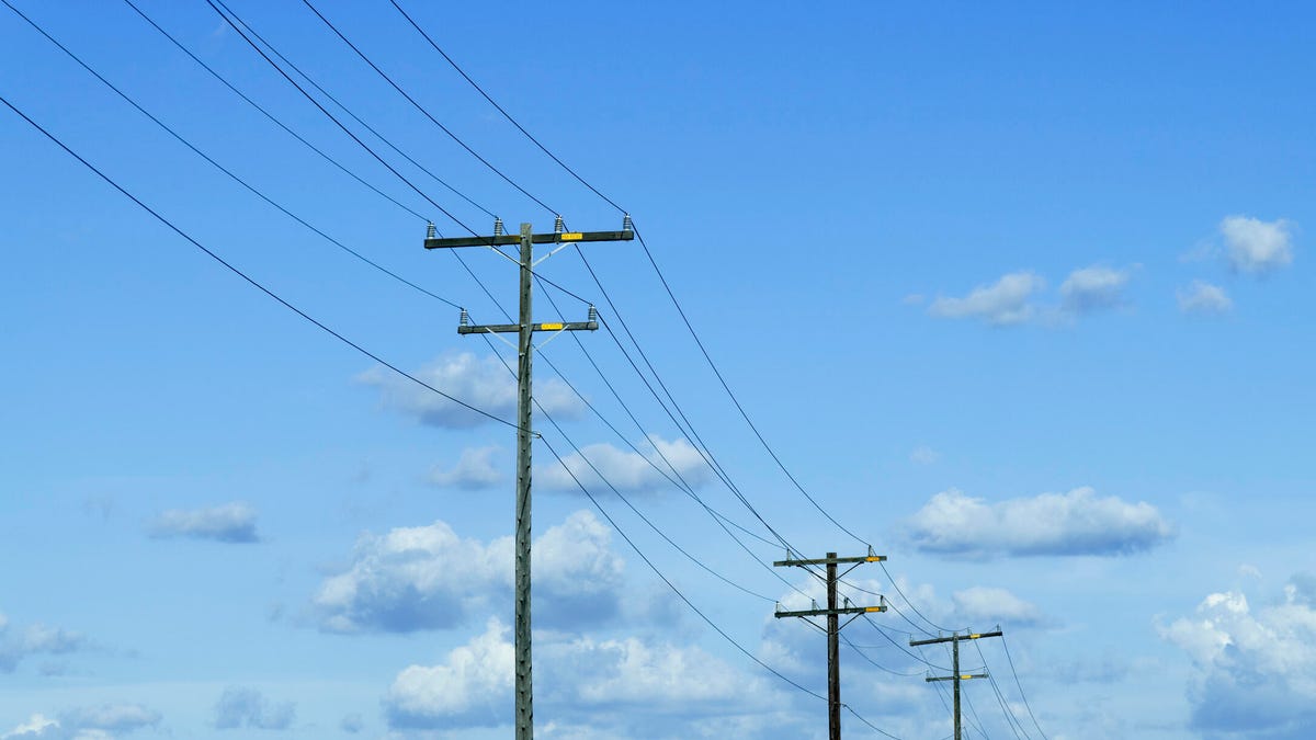 Power lines with clouds in the background