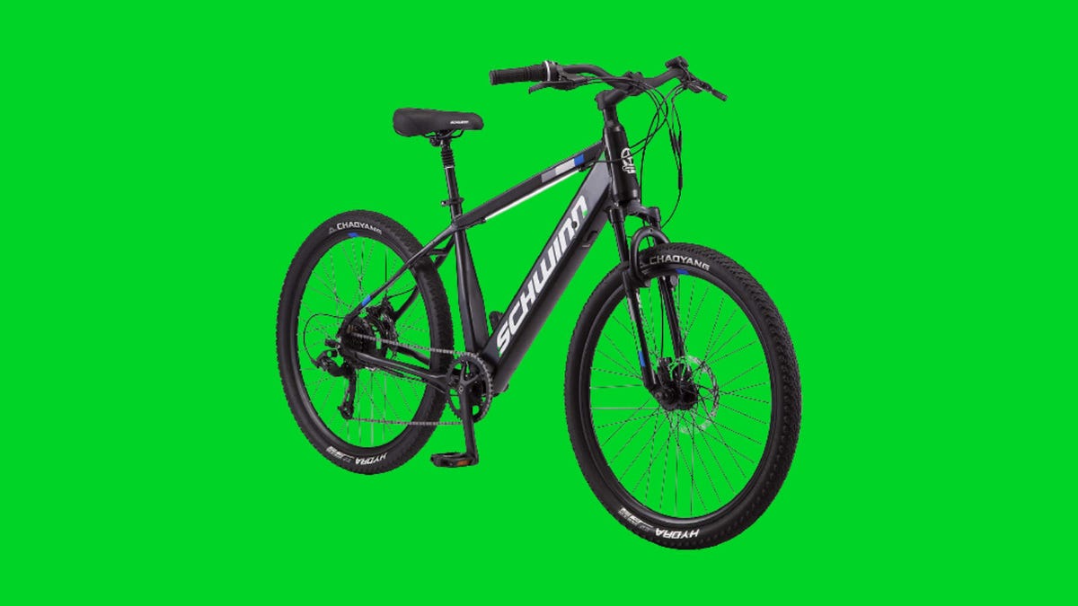 A black Schwinn E-bike against a green background.