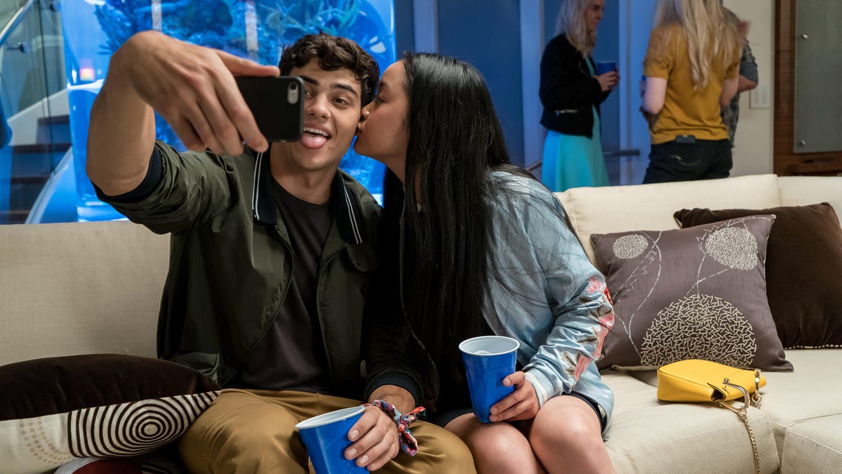 Characters from the movie take a selfie of themselves kissing and making silly faces