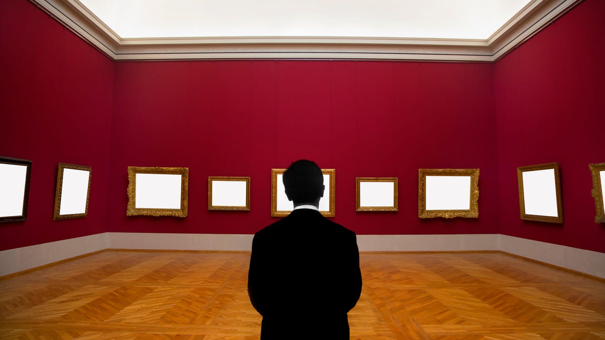 Photo illustration of a man staring at a gallery of blank frames.