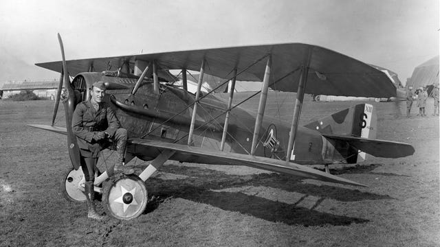 Eddie Rickenbacker strikes a jaunty pose with his Spad S.XIII biplane