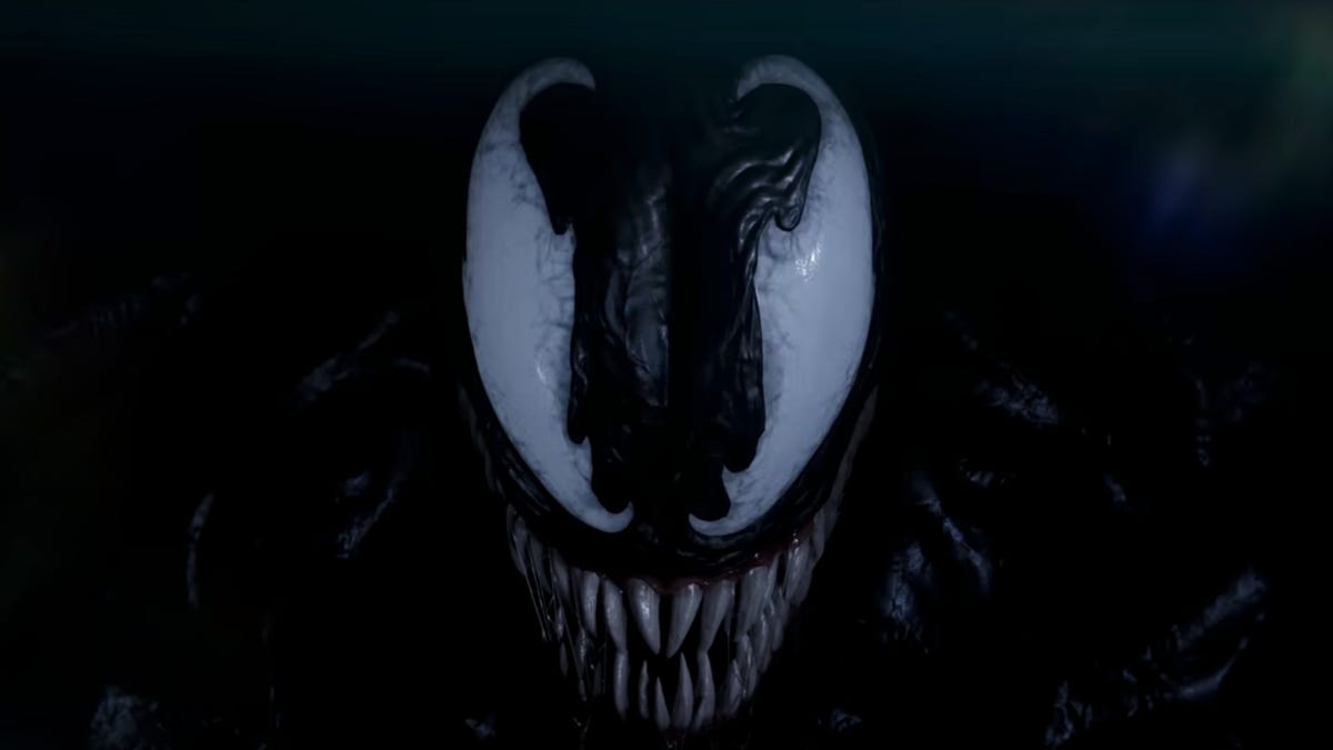 Venom's eyes and teeth are visible against a black background in the Spider-Man 2 game