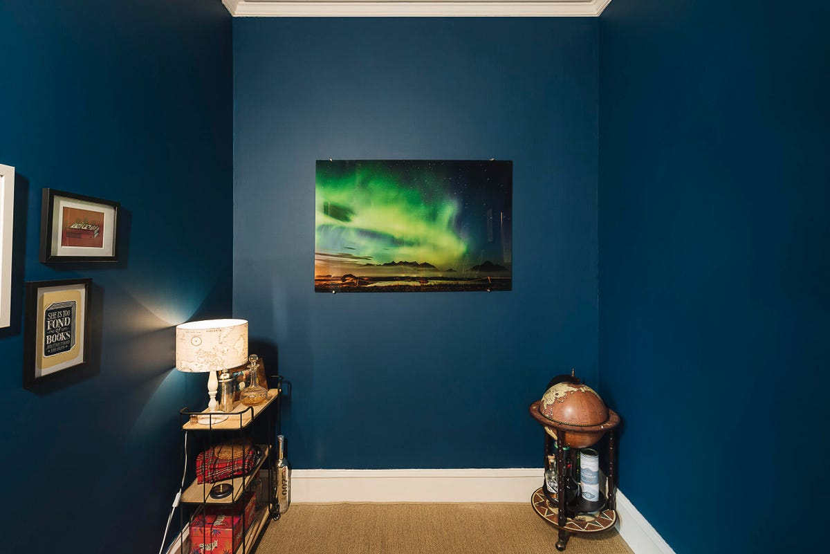 Image of a colorful print hanging in a blue room