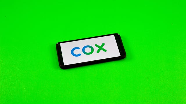 COX logo on a phone against green background