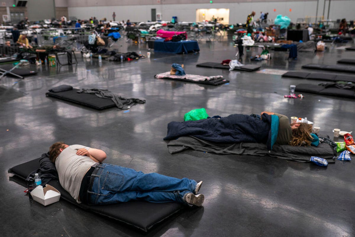 People sleeping on the floor at a cooling center in Portland, Oregon