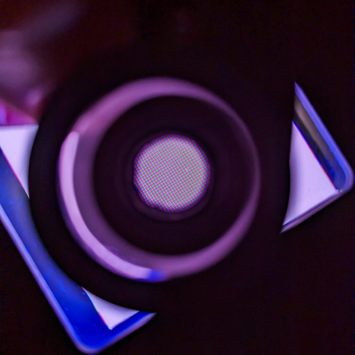 A magnifying lens showing red, green, and blue pixels from a quantum dot color conversion film demo display.