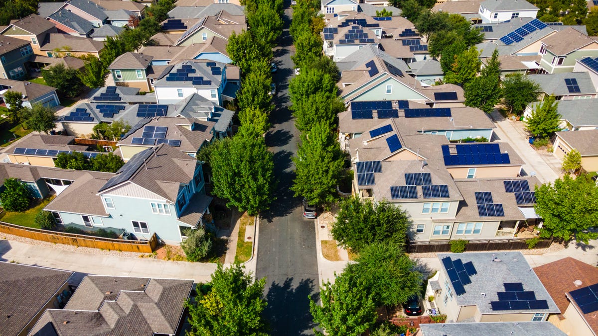 an aerial drone photograph of solar panels on roofs of houses in Austin, Texas