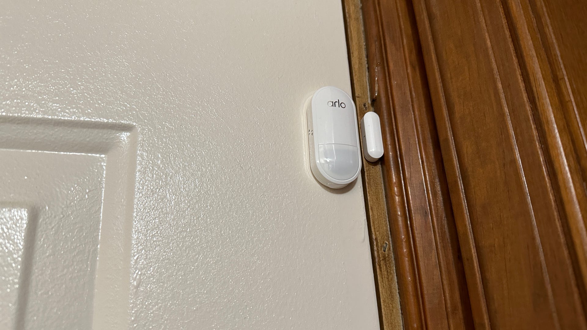 The Arlo Home Security System's multi-sensor mounted on a door frame to track comings and goings.