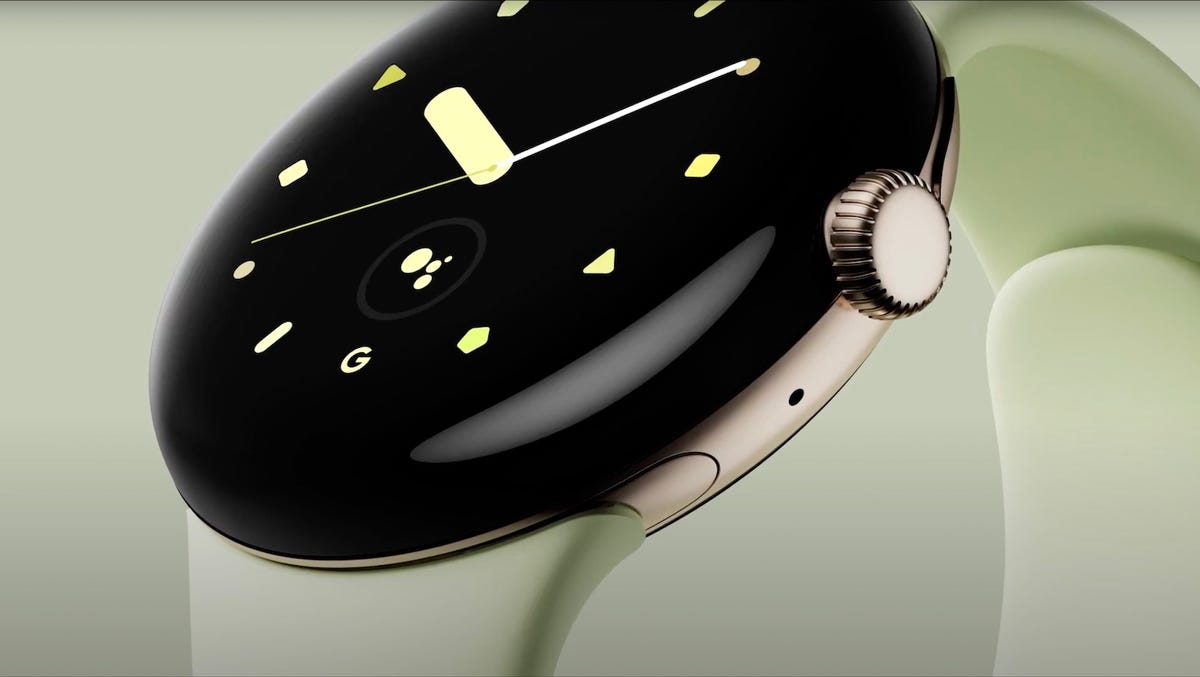An enlarged image of the Pixel Watch, likely a render, showing the front and side crown of the smartwatch.