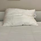 Cozy Earth silk pillow on a white bed