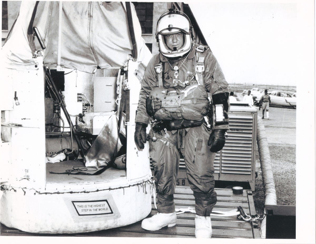 Joe Kittinger in high-altitude parachute gear next to the capsule he'll jump out of