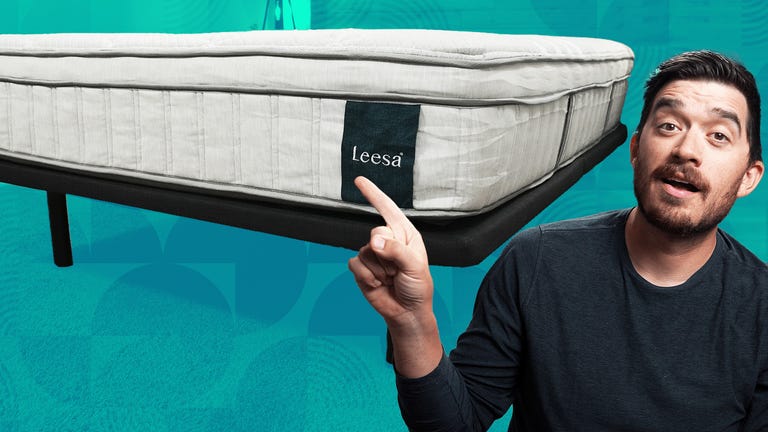 The Leesa Oasis mattress against a colorful background with a man in a longsleeve shirt the front.