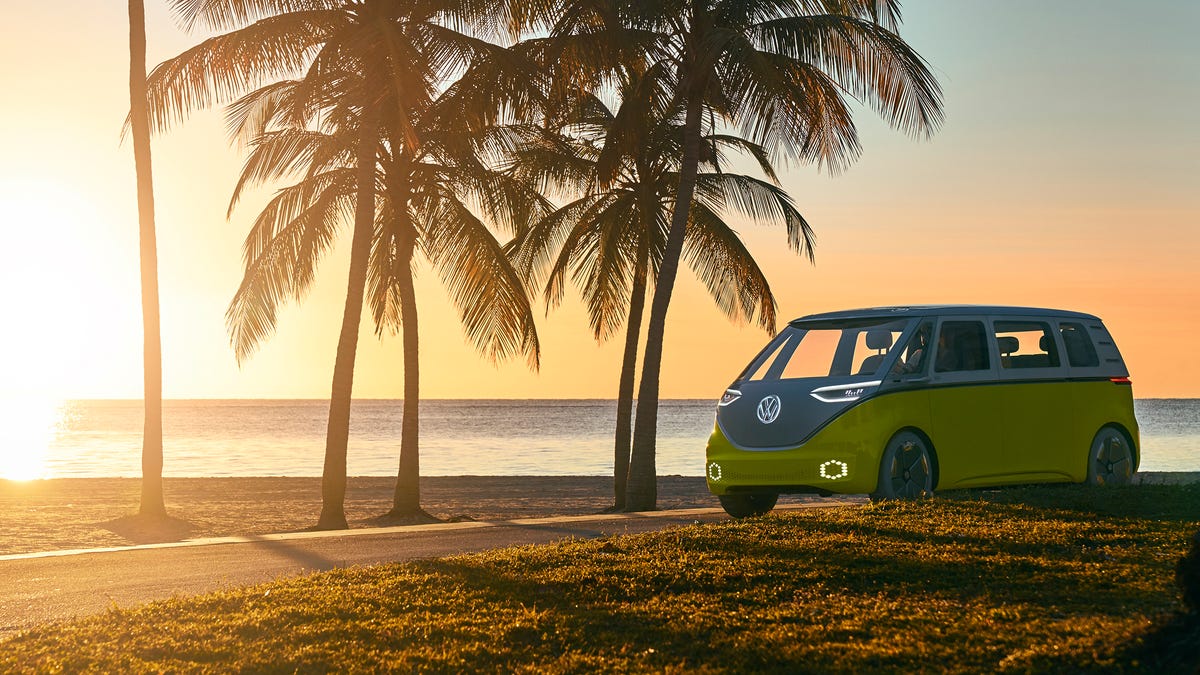 Volkswagen ID Buzz electric van on a beach with palm trees