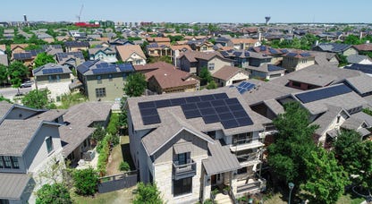 Solar panels on roofs in a neighborhood.