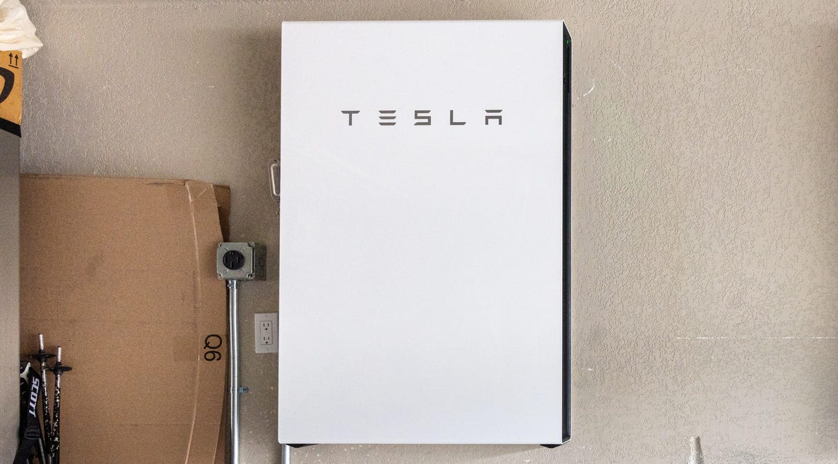 A Tesla Powerwalls mounted to a garage wall