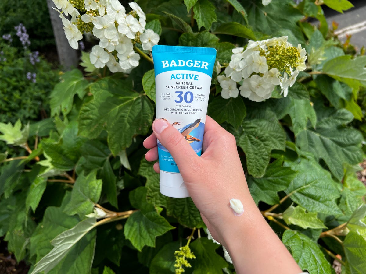 A hand holding Badger Active Sunscreen