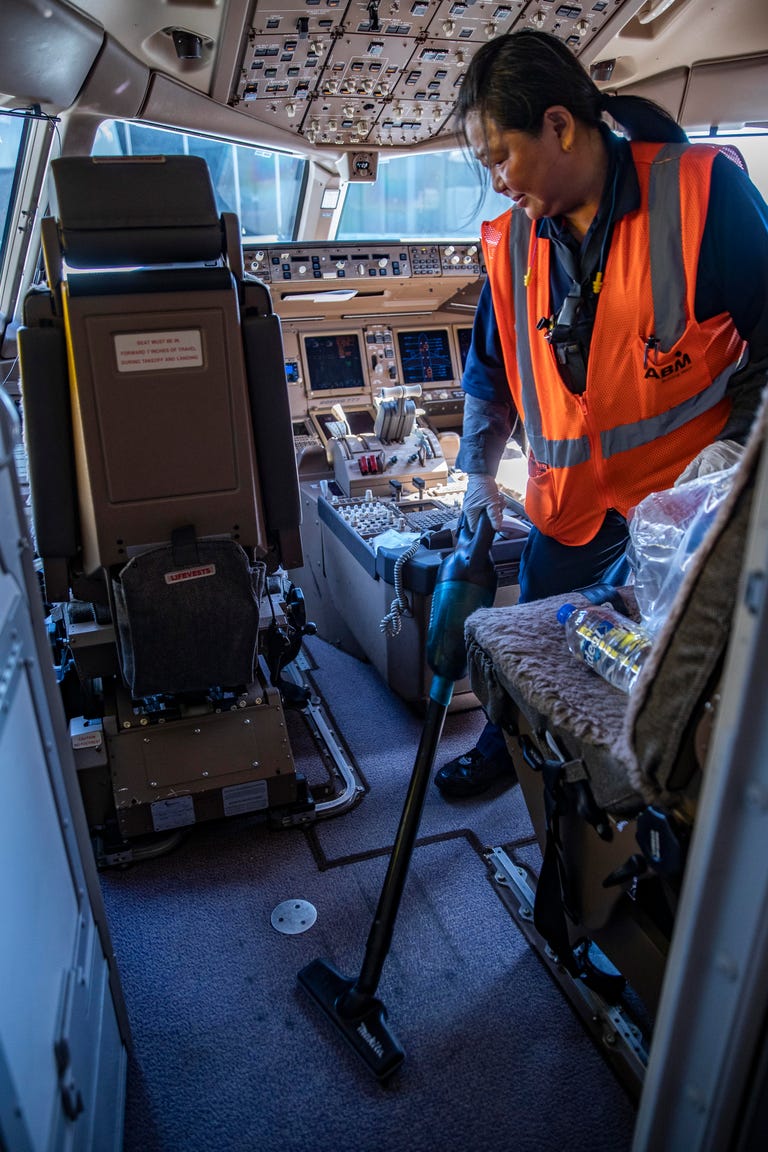 Cleaning the cockpit of a United Boeing 777.