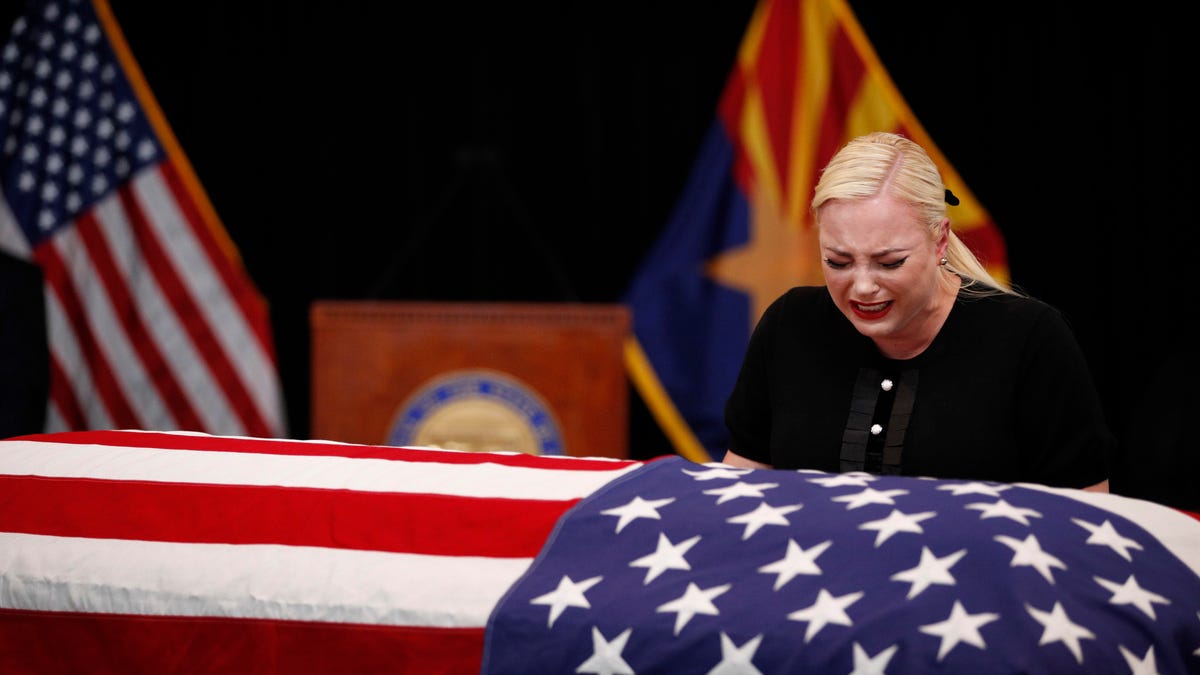 Meghan McCain, daughter of Sen. John McCain, touches the casket during a memorial service at the Arizona Capitol on Aug. 29. This image was edited to show a gun pointing at her, and the doctored photo was posted on Twitter for hours before the social network deleted it.