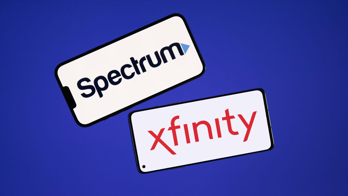 Spectrum and Xfinity logos on two phones
