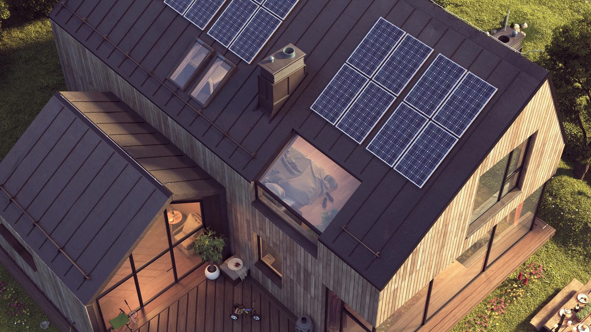 A house with solar panels on top of it.