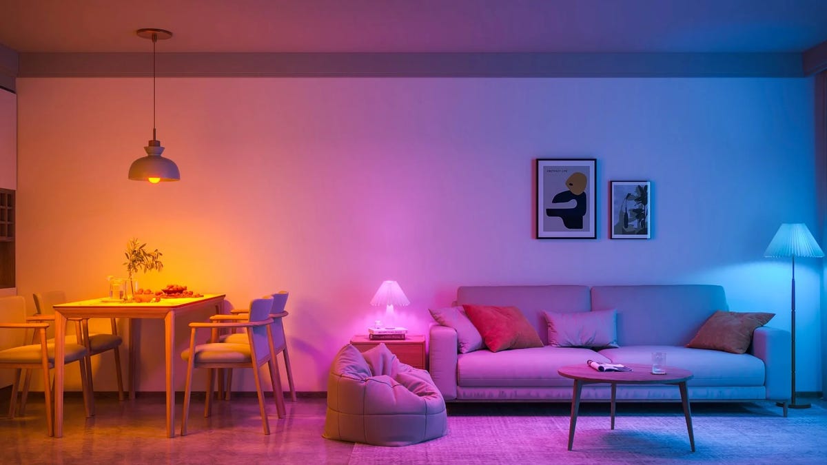 Govee smart bulbs in different lamps showing orange, magenta and turquoise colors in the home