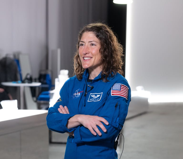 Christina Koch in a blue astronaut suit