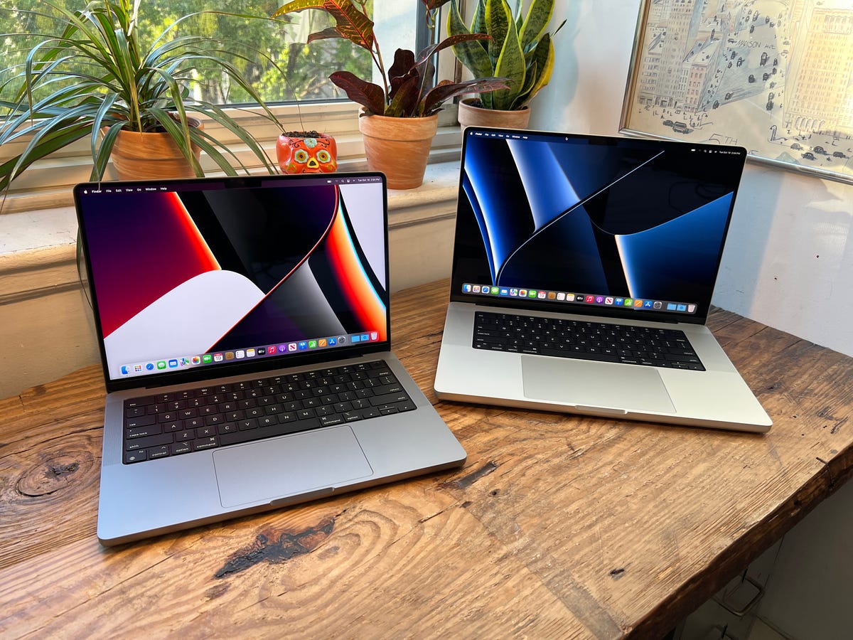 Two MacBook Pro 2021 models open on a desk.