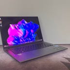 Acer Swift X 14 OLED ultraportable at an angle against a gray wall