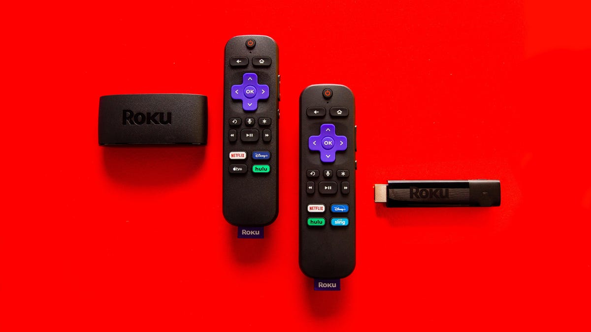 Two Roku streaming devices and remotes side-by-side against a red background. 
