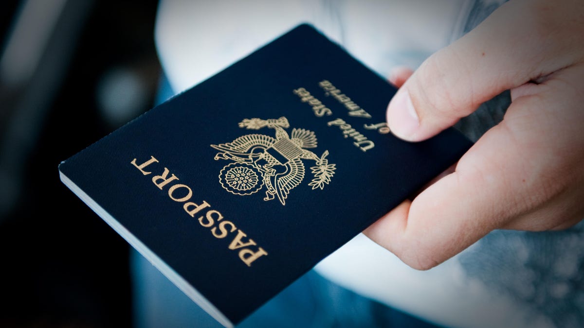 Close-Up Of Hand Holding Passport