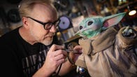 <p>Former MythBusters and professional tinkerer Adam Savage modifies a Baby Yoda toy adding posable arms and weathering its cloak.</p>