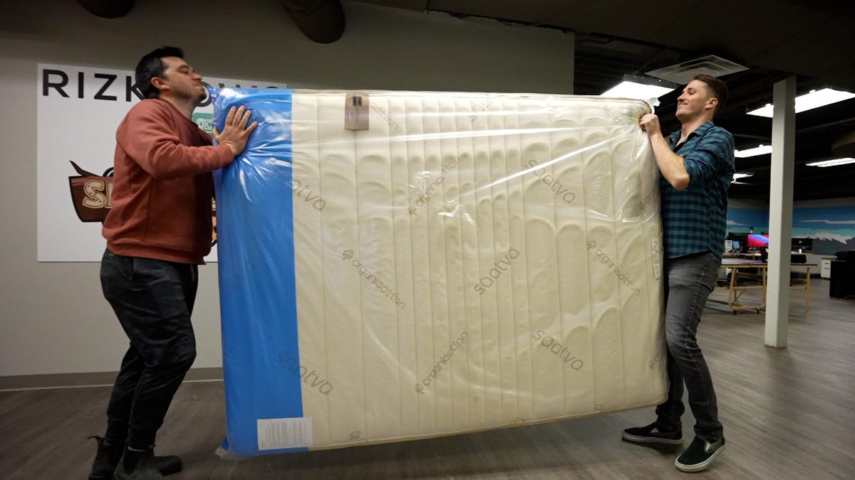 Two CNET Video producers moving a mattress