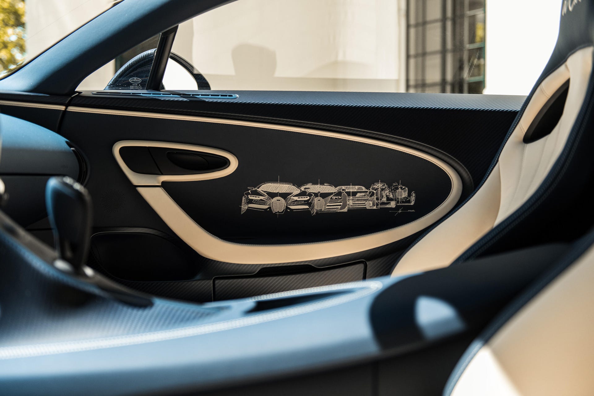 Bugatti Chiron L'Ébé door panel showing stitched artwork of Bugatti cars