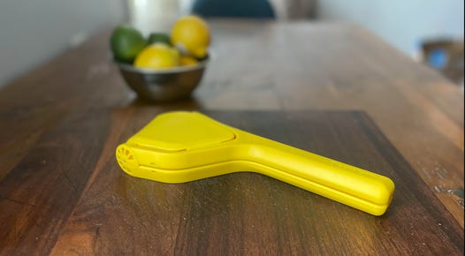 citrus juicer with lemons and limes